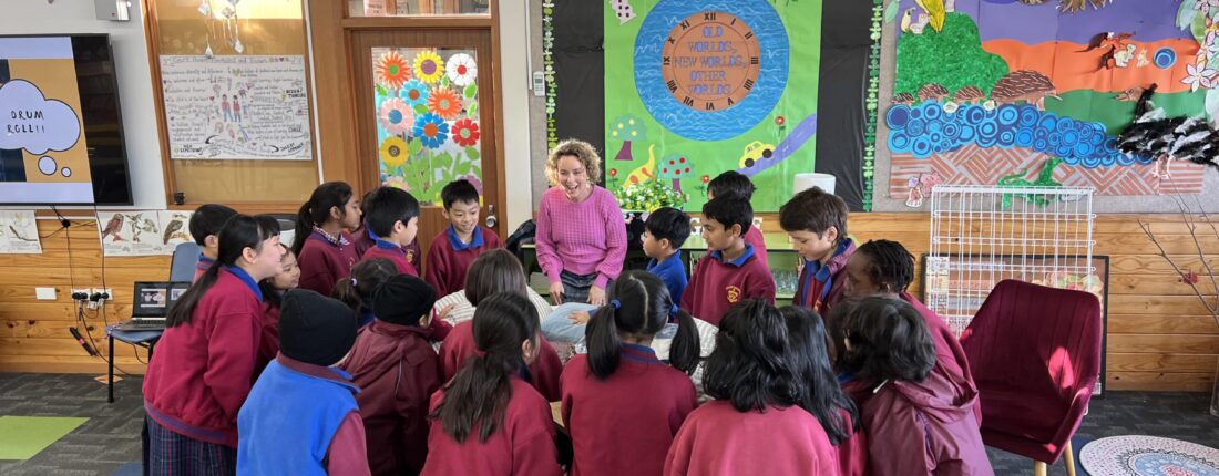 Children in a classroom with Author